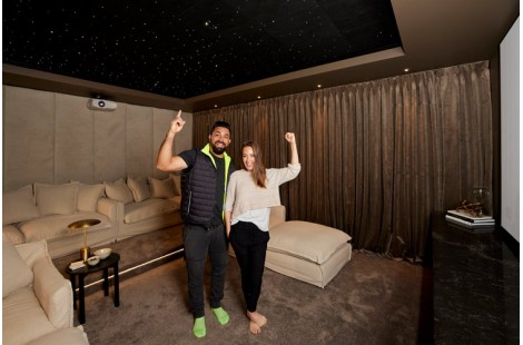 Ronnie and Georgia proudly standing in their home theatre with a StarEFX ceiling.
