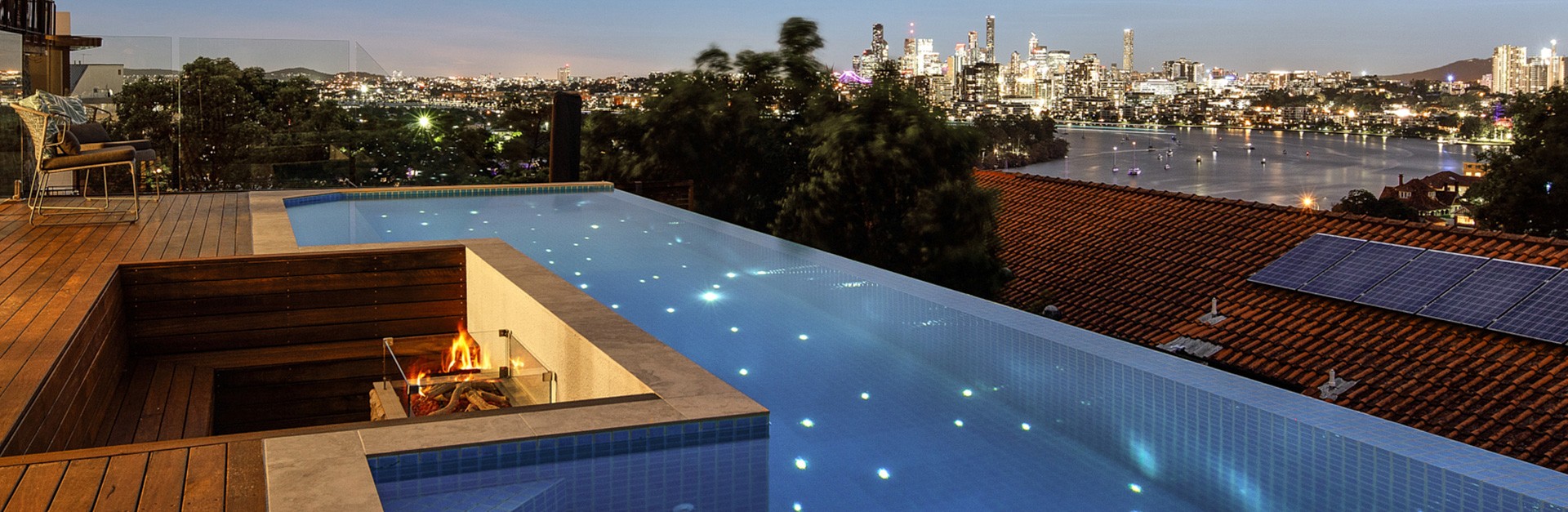 Text: StarEFX star lights illuminating a city-view swimming pool