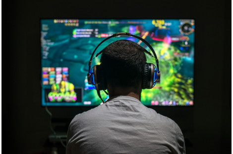 Young Gamer Playing Video Game Wearing Headphone.