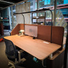 LightEFX Shift desk light installed on a commercial office hot desk with privacy screen and monitor